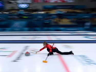 TOPSHOT - Canada's Kaitlyn Lawes throws the stone during the curling mixed doubles semi-final during the Pyeongchang 2018 Winter Olympic Games at the Gangneung Curling Centre in Gangneung on February 12, 2018.
