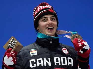 TOPSHOT - Canada's bronze medallist Mark McMorris poses on the podium during the medal ceremony for the snowboard Men's Slopestyle at the Pyeongchang Medals Plaza during the Pyeongchang 2018 Winter Olympic Games in Pyeongchang on February 11, 2018.