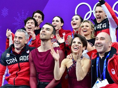 TOPSHOT - Canada's Meagan Duhamel (centre R) and Canada's Eric Radford (centre L) react after competing in the figure skating team event pair skating free skating during the Pyeongchang 2018 Winter Olympic Games at the Gangneung Ice Arena in Gangneung on February 11, 2018.