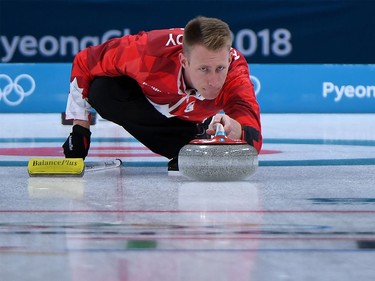 Canada's Marc Kennedy throws the stone during the curling men's round robin session between Canada and Italy during the Pyeongchang 2018 Winter Olympic Games at the Gangneung Curling Centre in Gangneung on February 14, 2018.