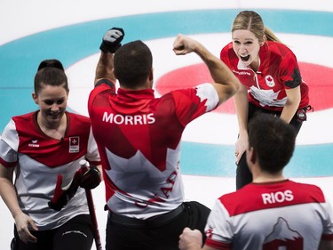 Canadians Kaitlyn Lawes, top right and John Morris, centre, react after defeating Switzerland to win gold during mixed doubles curling action at the 2018 Olympic Winter Games in Gangneung, South Korea on Tuesday, February 13, 2018.