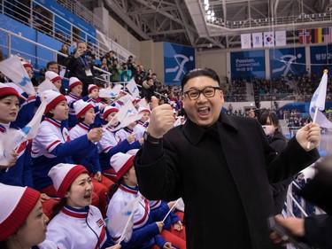 A man impersonating North Korean leader Kim Jong Un gestures as he stands before North Korean cheerleaders attending the Unified Korean ice hockey game against Japan during the Pyeongchang 2018 Winter Olympic Games at the Kwandong Hockey Centre in Gangneung on February 14, 2018.