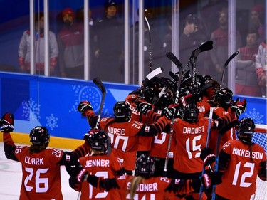Canada's players celebrate winning the women's preliminary round ice hockey match between the US and Canada during the Pyeongchang 2018 Winter Olympic Games at the Kwandong Hockey Centre in Gangneung on February 15, 2018.