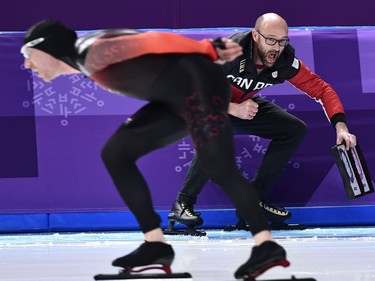 Canada's Ted-Jan Bloemen skates past his coach as he competes in the men's 10,000m speed skating event during the Pyeongchang 2018 Winter Olympic Games at the Gangneung Oval in Gangneung on February 15, 2018.