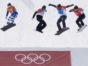 Snowboarders race in a quarter final race of snowboard cross at the Phoenix Snow Park during the Pyeongchang 2018 Winter Olympic Games in South Korea, Thursday, Feb. 15, 2018.