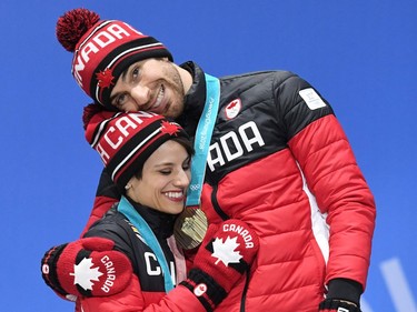 Canada's bronze medallists Meagan Duhamel (L) and Eric Radford pose on the podium during the medal ceremony for the figure skating pair event at the Pyeongchang Medals Plaza during the Pyeongchang 2018 Winter Olympic Games in Pyeongchang on February 15, 2018.