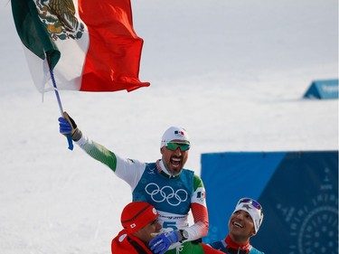 Tonga's Pita Taufatofua (L) and Morocco's Samir Azzimani (R) lift Mexico's German Madrazo onto their shoulders as they celebrate at the finish line in the men's 15km cross country freestyle at the Alpensia cross country ski centre during the Pyeongchang 2018 Winter Olympic Games on February 16, 2018 in Pyeongchang.