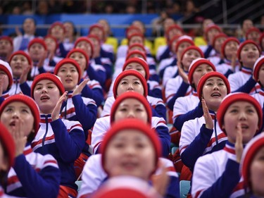 North Korean cheerleaders watch the men's preliminary round ice hockey match between South Korea and Czech Republic during the Pyeongchang 2018 Winter Olympic Games at the Gangneung Hockey Centre in Gangneung on February 15, 2018.
