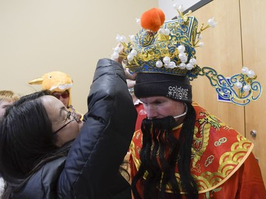 Richard Martin from Chinatown Showboat dragon boat team dresses up as king of fortune prior to Chinese New Year celebration at Plant recreation centre on Saturday, Feb. 17, 2018.