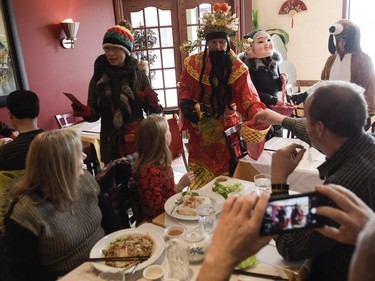 Volunteers for Chinese New Year celebration stops by local businesses on Somerset street such as Vietnam Palace restaurant to give out red envelopes for money and good fortune on Saturday, Feb. 17, 2018.