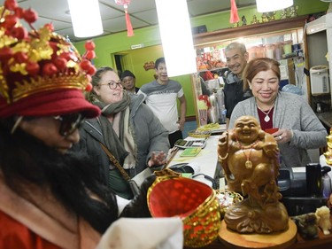 Volunteers for Chinese New Year celebration stops by local businesses on Somerset street to give out red envelopes for money and good fortune on Saturday, Feb. 17, 2018.