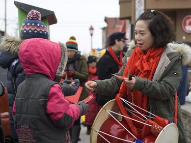 Amy Tao, volunteer for Chinese New Year celebration gives out red envelopes for money and good fortune on Saturday, Feb. 17, 2018.