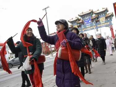 Volunteers perform flower drum dance as they walk down Somerset street to celebrate Chinese New Year on Saturday, Feb. 17, 2018.