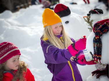 Eight-year-old Kathleen Murphy (middle) works with a spray bottle to freeze her snowman in place. 
The Crackup Snowmania Challenge took place Saturday Feb 17, 2018 at Lansdowne Park.
