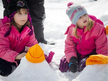 L-R seven and a half year old Racheal Born and her sister six-year-old Katherine work away at building their snowmen.   The Crackup Snowmania Challenge took place Saturday Feb 17, 2018 at Lansdowne Park.