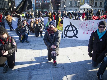 Anti-racist protesters knelt O Canada was performed on Parliament Hill. 

Ashley Fraser/Postmedia