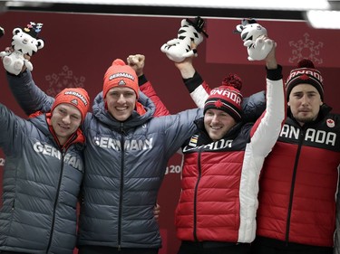 From left, driver Francesco Friedrich and Thorsten Margis of Germany and driver Justin Kripps and Alexander Kopacz of Canada celebrate during the two-man bobsled final at the 2018 Winter Olympics in Pyeongchang, South Korea, Monday, Feb. 19, 2018. The two countries tied for a gold medal.