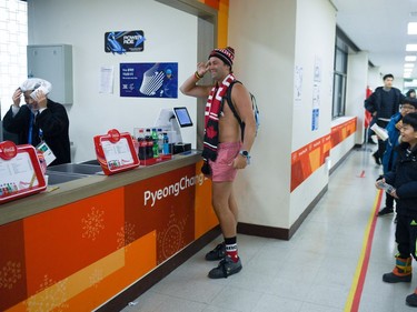 TOPSHOT - A Canada's fan arrives undressed at curling venue for the curling men's round robin session between the US and Canada during the Pyeongchang 2018 Winter Olympic Games at the Gangneung Curling Centre in Gangneung on February 19, 2018.