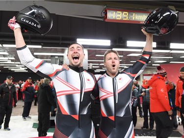 Canadians Justin Kripps, right, and Alexander Kopacz celebrate their tie with Germany for the gold medal after the men's two-man bobsled finals at the 2018 Winter Olympic Games in Pyeongchang, South Korea, Sunday, Feb. 18, 2018.