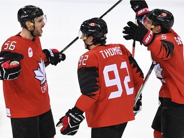 Canada's Maxim Noreau (L) celebrates after scoring a goal in the men's quarter-final ice hockey match between Finland and Canada during the Pyeongchang 2018 Winter Olympic Games at the Gangneung Hockey Centre in Gangneung on February 21, 2018.