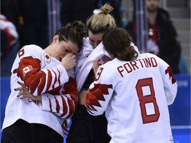 Players from Team Canada react after being defeated in the women's gold medal ice hockey match between Canada and the US during the Pyeongchang 2018 Winter Olympic Games at the Gangneung Hockey Centre in Gangneung on February 22, 2018.