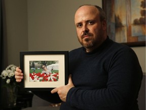 Donald Marengère poses with a photo of his late wife Cynthia Thibaudeau in Gatineau on Thursday, Feb. 22, 2018. Thibaudeau died of complications from the flu at the age of 39.