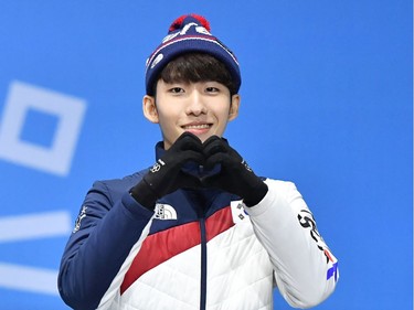 South Korea's bronze medallist Lim Hyojun makes a heart shape as he poses on the podium during the medal ceremony for the short track Men's 500m at the Pyeongchang Medals Plaza during the Pyeongchang 2018 Winter Olympic Games in Pyeongchang on February 23, 2018.