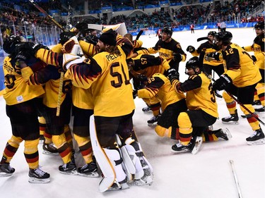 Germany's players celebrate winning the men's semi-final ice hockey match between Canada and Germany during the Pyeongchang 2018 Winter Olympic Games at the Gangneung Hockey Centre in Gangneung on February 23, 2018.