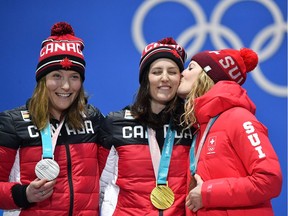 Canada's silver medallist Brittany Phelan, Canada's gold medallist Kelsey Serwa and Switzerland's bronze medallist Fanny Smith pose on the podium during the medal ceremony for the freestyle skiing Women's Ski Cross at the Pyeongchang Medals Plaza during the Pyeongchang 2018 Winter Olympic Games in Pyeongchang on February 23, 2018.