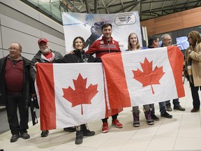 Speed skater Vincent De Haitre poses for a photo with fans and family at Ottawa airport on Monday, Feb. 26, 2018.