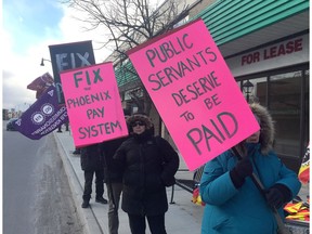About a dozen federal employees gather during a picket regarding the Phoenix Pay System in front of Kingston and the Island M.P. Mark Gerretsen's constituency office on Friday March 10 2017.