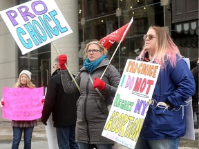 A small group of abortion-rights advocates stood at the corner of Sparks and Bank streets, just steps from the Morgentaler Clinic on Bank, to show their support for the new legislation.