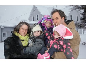 Matt Dewan and Katrina Arcand (with children Brunson, Billie, and Brantley) believe their hard hundreds of bats in the colony in their attic.