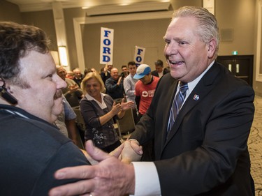 Ontario PC leadership candidate, Doug Ford, right, is greeted by supporters a rally at the Infinity Convention Centre in Ottawa Monday, February 19, 2018 (Photo/Darren Brown)