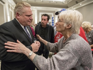 Ontario PC leadership candidate, Doug Ford, left, meets with supporters after speaking at a rally at the Infinity Convention Centre in Ottawa Monday, February 19, 2018 (Photo/Darren Brown)