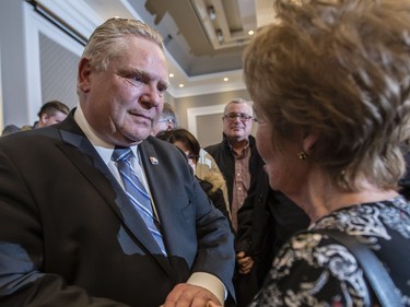 Ontario PC leadership candidate, Doug Ford, left meets with supporters after speaking at a rally at the Infinity Convention Centre in Ottawa Monday, February 19, 2018 (Photo/Darren Brown)