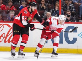 Ben Harpur has his stick held by the Red Wings' Gustav Nyquist during a game on Oct. 7. That game was during one of Harpur's previous NHL callups to the Senators this season.