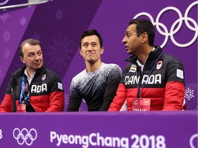 Canadian figure skater Patrick Chan, middle, reacts after competing during the short program on Friday.