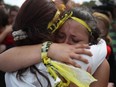 Madison Fox is hugged as the West Boca High School student joined hundreds of fellow students that walked to Marjory Stoneman Douglas High School in honor of the 17 students shot dead last week on February 20, 2018 in Parkland, Florida.