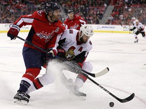 Senators forward Zack Smith tries to fight off a check by the Capitals' Brooks Orpik during the third period of Tuesday's game in Washington.