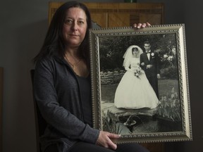 Sonia Perna holds a photo from her parents' wedding day.