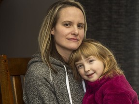 Meredith Phillips with her six-year-old step-daughter Olivia Jamer-Martin. A federal civil servant, Phillips received no pay at all for more than three months after returning from maternity leave after giving birth to Olivia's sister, two years ago.