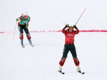 Silver medalist Brittany Phelan (L) and gold medalist Kelsey Serwa (R) of Canada celebrate their accomplishment as they cross the finish line of the women's ski cross finals held at Phoenix Snow Park during the 2018 Winter Olympics in South Korea, February 23, 2018.