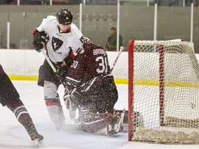 The Ravens' Adam Chapman slides into Gee-Gees netminder Anthony Brodeur during Game 3 on Sunday night. Marc Lafleu/Carleton photo