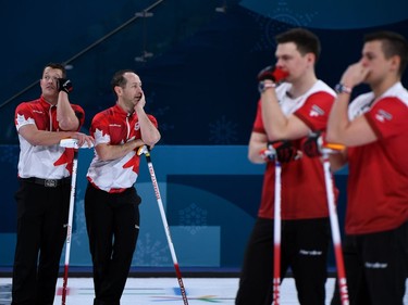 Canada's Ben Hebert (L)and Brent Laing (2nd L)look on during the curling men's round robin session between Canada and Sweden during the Pyeongchang 2018 Winter Olympic Games at the Gangneung Curling Centre in Gangneung on February 17, 2018.