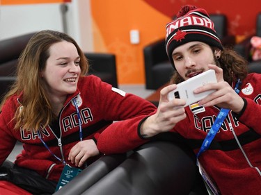 Canada's short track gold medallist Samuel Girard (R) and Canada's short track bronze medallist Kim Boutin chat backstage at the Athletes' Lounge during the medal ceremonies at the Pyeongchang Medals Plaza during the Pyeongchang 2018 Winter Olympic Games in Pyeongchang on February 18, 2018.