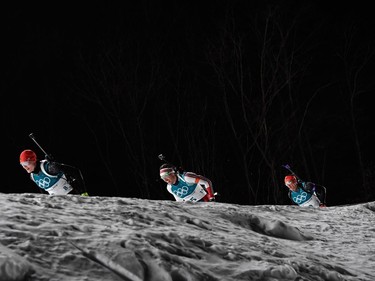 Germany's Benedikt Doll (L), Norway's Emil Hegle Svendsen and Germany's Erik Lesser compete in the men's 15km mass start biathlon event during the Pyeongchang 2018 Winter Olympic Games on February 18, 2018, in Pyeongchang.