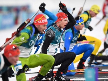 Athletes compete at the shooting range in the men's 15km mass start biathlon event during the Pyeongchang 2018 Winter Olympic Games on February 18, 2018, in Pyeongchang.