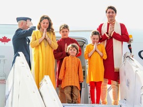 In this photograph released by the Gujarat Information Bureau on February 19, 2018, Canadian Prime Minister Justin Trudeau (R), his wife Sophie Gregoire Trudeau (2L), their daughter Ella-Grace (2R ) and their sons Hadrien (C) and Xavier pose for media as they arrive at the airport in the Indian city of Ahmedabad.