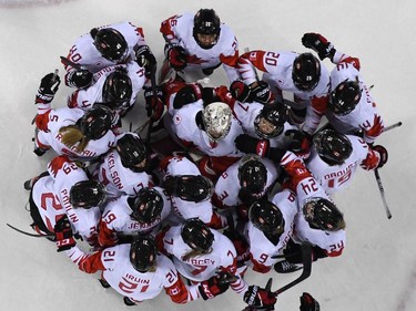 TOPSHOT - Team Canada huddle after they won the women's semi-final ice hockey match between Canada and the Olympic Athletes from Russia during the Pyeongchang 2018 Winter Olympic Games at the Gangneung Hockey Centre in Gangneung on February 19, 2018.